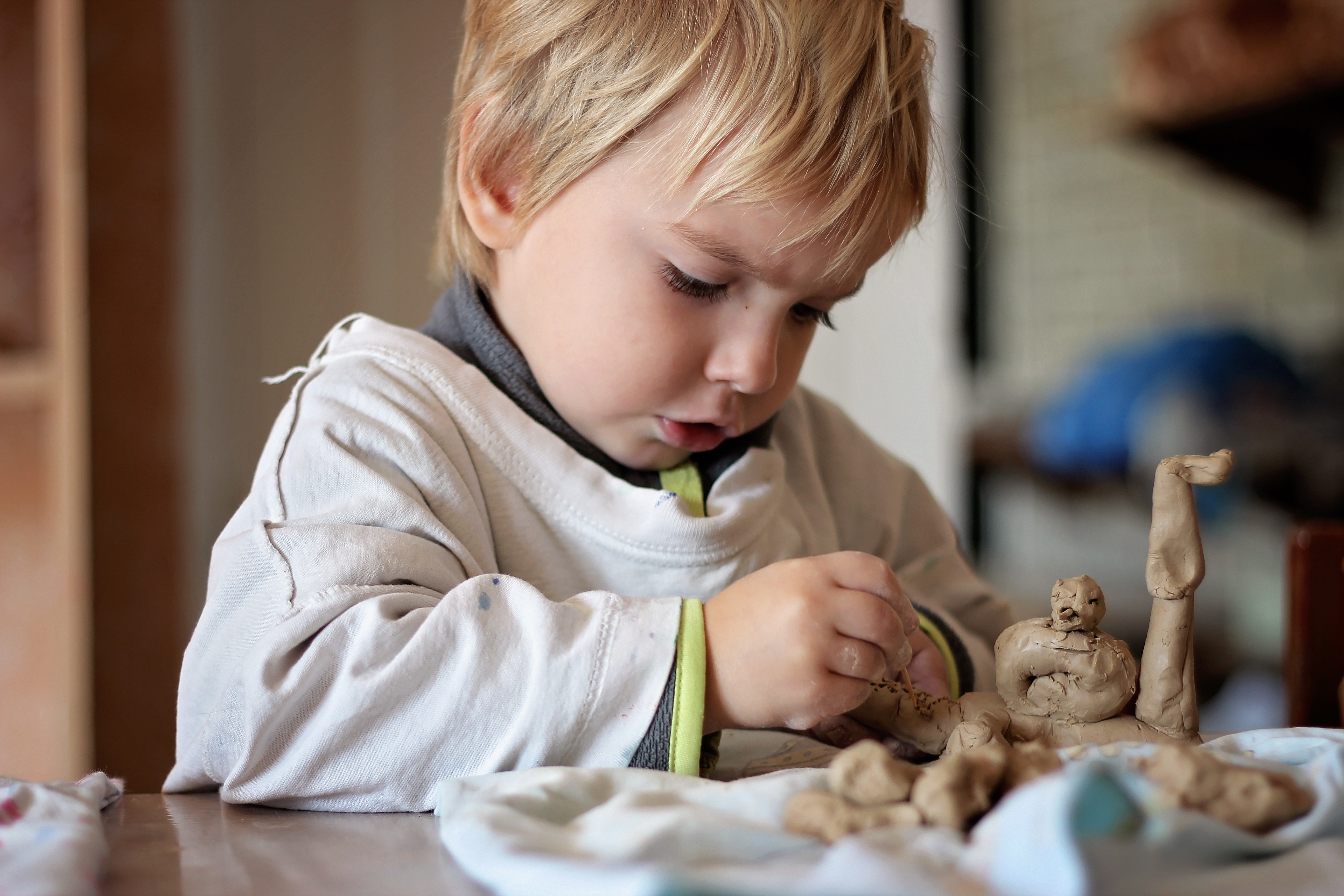 Cute,Little,Kid,Playing,With,Modeling,Clay,In,Pottery,Workshop,